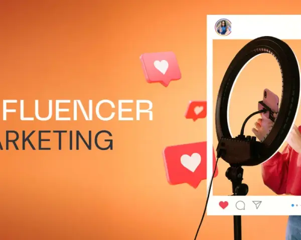 Influencer tworzy treści, budując **earned media**. Wokół niej pojawiają się serduszka, symbolizujące zaangażowanie odbiorców.