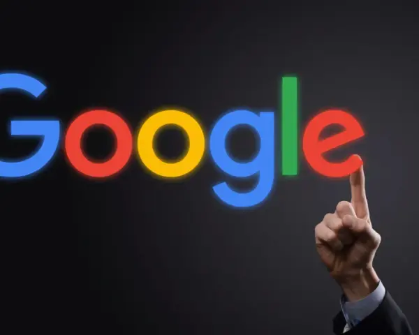 Palec wskazujący dotyka litery "e" w neonowym logo Google. To symbol tego, google co to jest - wyszukiwarka, która łączy nas ze światem.
